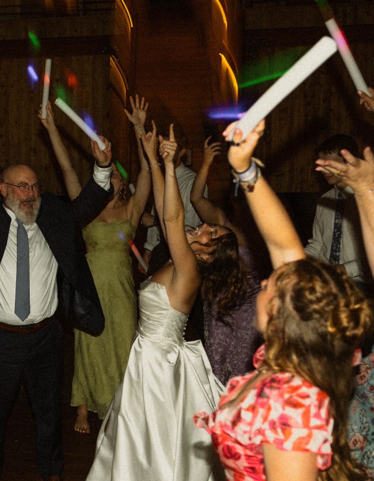 Bride raising her hands and celebrating with wedding guests