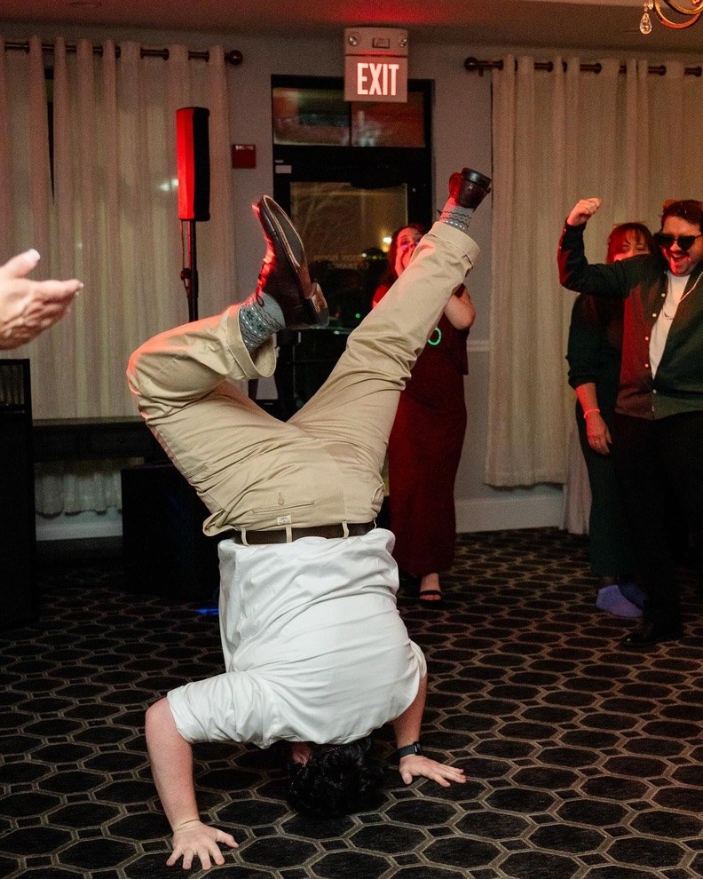 Guest breakdancing while friends cheer