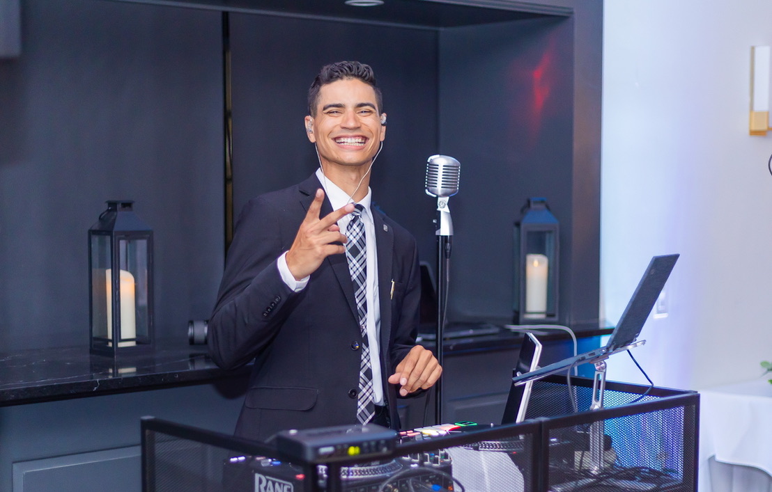 DJ KEVIN smiling behind the DJ booth