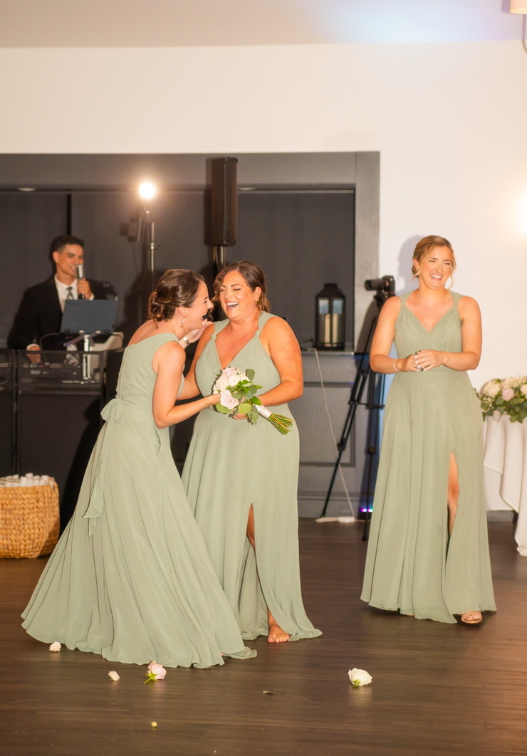 Bridesmaids laughing together during the reception