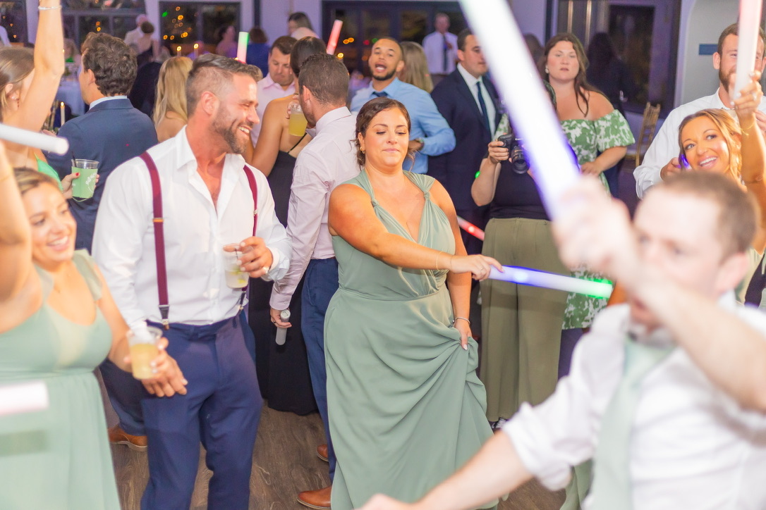 Wedding guests filling a bright dance floor