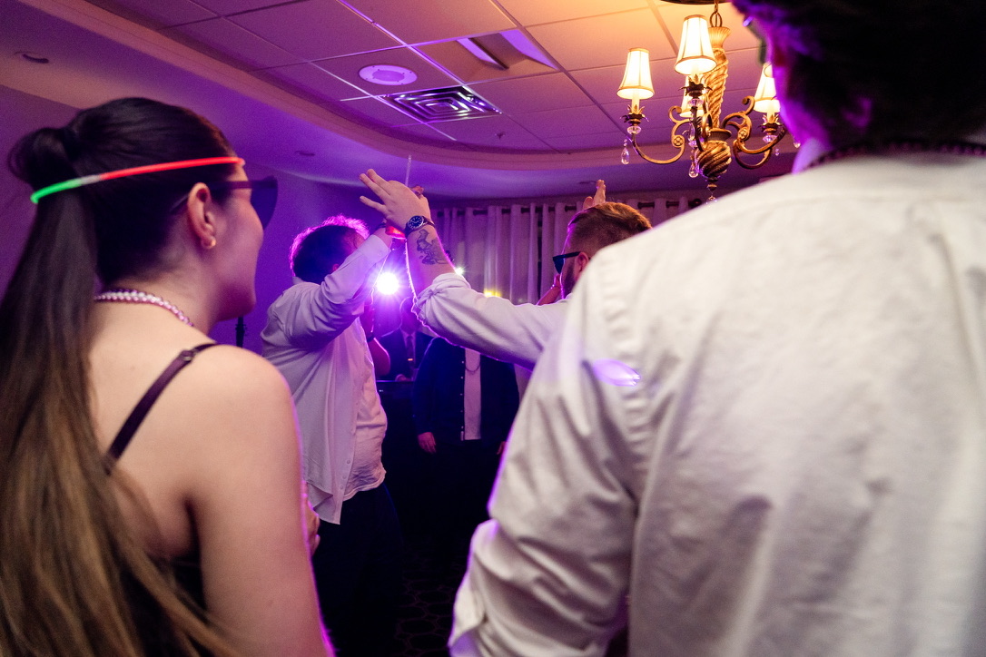 Guests dancing under purple reception lighting